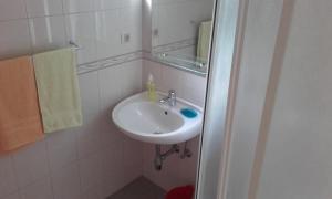 a bathroom with a sink and a mirror at Apartments Ivka in Omiš +83 photos