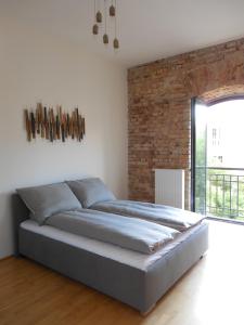 A bed or beds in a room at The Old Mill Budapest