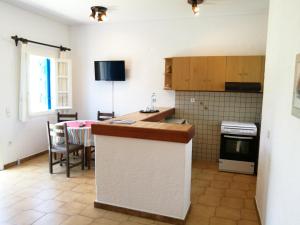 a kitchen with a counter and a table in a room at House near Sea in Gavrio