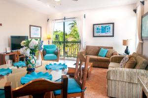 a living room with a couch and a table at Abbey Del Sol in Puerto Morelos