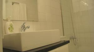 a bathroom with a sink and a mirror at Foz Gardens in Porto