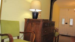 a lamp sitting on top of a dresser with a chair at Foz Gardens in Porto