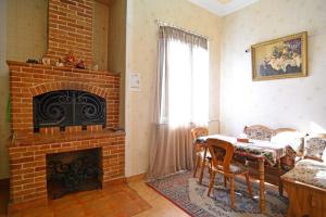 a living room with a brick fireplace and a table at Bridge House Yerevan Armenia in Yerevan