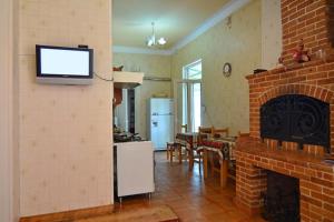 a living room with a fireplace and a tv on the wall at Bridge House Yerevan Armenia in Yerevan