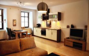 a living room with a couch and a kitchen at Apartments Altstadthaus Görlitz in Görlitz