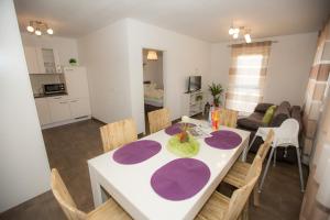 a kitchen and dining room with a table and chairs at Family Apartments in Rust