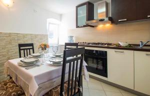 a kitchen with a table with plates and wine glasses at Karla Apartment in Labin