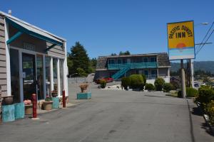 an empty street in a small town with a building at Pacific Sunset Inn in Brookings