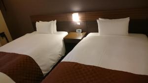 Postel nebo postele na pokoji v ubytování Hotel Ascent Plaza Hamamatsu