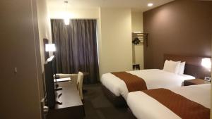 Postel nebo postele na pokoji v ubytování Hotel Ascent Plaza Hamamatsu