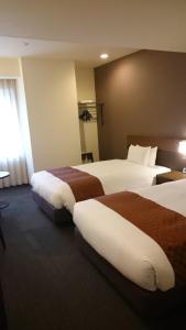 Postel nebo postele na pokoji v ubytování Hotel Ascent Plaza Hamamatsu