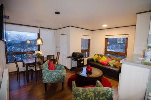 a living room with a couch and a table at Departamento Andes Chillan in Nevados de Chillan