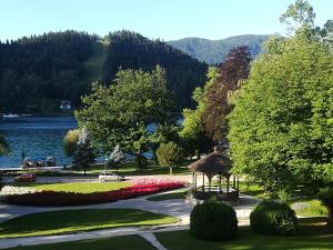 a park with a gazebo next to a lake at MB apartment Bled in Bled