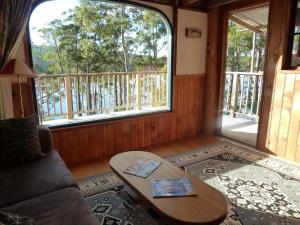 a living room with a couch and a table at Oyster Shack in Hastings