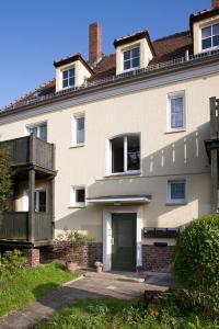 een groot wit huis met een groene deur bij Wohlfühloase Dresden Nickern in Dresden