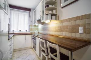 a kitchen with a wooden counter top and a window at Lovely Corvin Apartment in Budapest