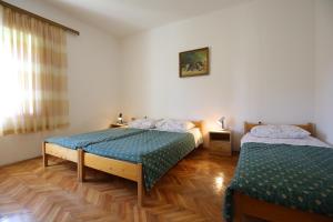 Postel nebo postele na pokoji v ubytování Apartment and rooms Roko