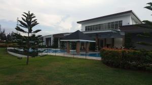 a large building with a swimming pool in front of it at Tagaytay Condotel in Tagaytay