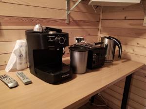 a counter top with a coffee maker and a coffee maker at Naktsmītne Lubānā in Lubāna +11 photos