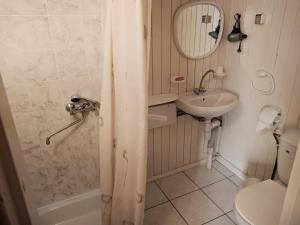 a bathroom with a sink and a toilet and a shower at Naktsmītne Lubānā in Lubāna