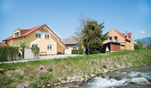 a house on a hill next to a river at Penzion Ajda in Liptovský Mikuláš +73 photos