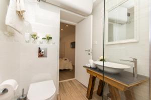 a bathroom with a sink and a toilet at Dubrovnik Finest Apartments in Dubrovnik +97 photos
