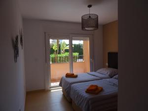 Giường trong phòng chung tại Coming Home - Mar Menor Resort