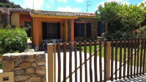 a wooden fence in front of a house at Splendida Villetta vicino al mare in Villasimius