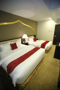 Postel nebo postele na pokoji v ubytování Al Khatiri Hotel