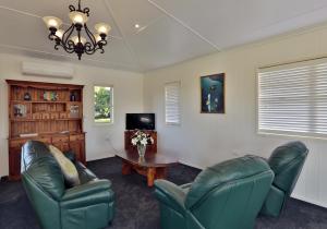 a living room with two chairs and a table at "Seasons of Maleny B&B" in Maleny