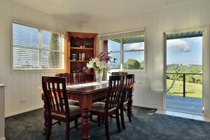 a dining room with a wooden table and chairs at "Seasons of Maleny B&B" in Maleny