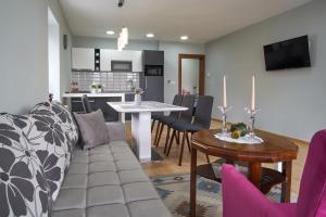 a living room with a couch and a table at Green Elite Residence in Sarajevo