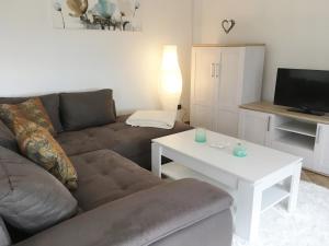 sala de estar con sofá y mesa en Ferienwohnung Bellevue, en Staufenberg