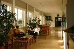 a woman and a child sitting in a waiting room at Jugendherberge Otto-Moericke-Turm in Konstanz