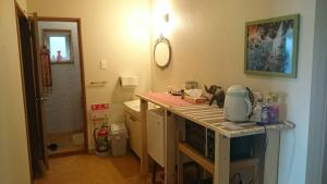 a kitchen with a counter with a mixer on it at Kakunodate Guesthouse Fuga in Senboku