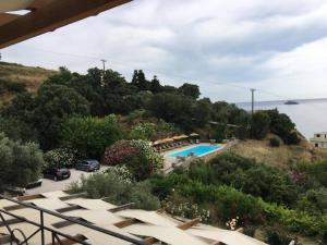 a view of a resort with a swimming pool at Vassiliki Studios in Andros