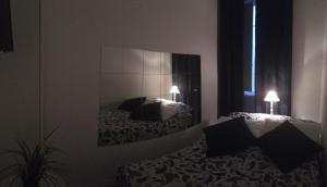 A bed or beds in a room at MiRhome Guest House