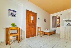 a living room with a wooden door and a table at Villa Diasselo in Malia
