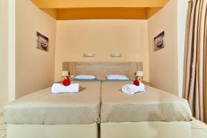 a bedroom with a bed with two pillows on it at Villa Diasselo in Malia