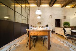 a large kitchen with a wooden table and chairs at Casatorre dei Leoni Dimora Storica in Siena