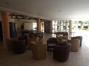 a restaurant with tables and chairs in a room at CONDOMÍNIO VILA DO MAR in Aquiraz