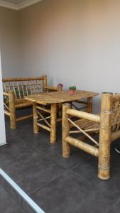 a wooden table and bench in a room at Shalva Apartment in Chakvi