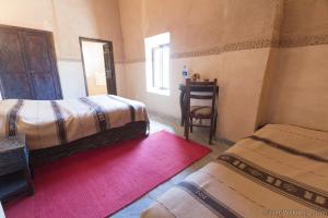 Voodi või voodid majutusasutuse Kasbah Imdoukal toas