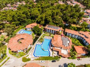 an aerial view of a mansion with a pool and a resort at Yucelen Hotel in Akyaka