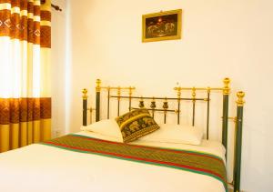 Postel nebo postele na pokoji v ubytování Kandy Riverside Villa