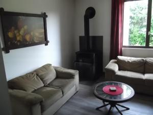a living room with a couch and a table at 43 Rue des Quarts in Ménesplet