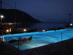 a swimming pool at night with blue lights at Katerina Lefkada in Vasiliki