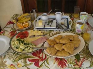 a table with two plates of food on it at Gemini House Bed & Breakfast in Christ Church