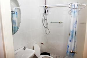 a bathroom with a shower and a toilet at Baan Pordee Homestay in Phayayen +16 photos