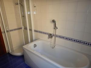 a bath tub in a bathroom with a shower at Bed and Breakfast Relax in Trento